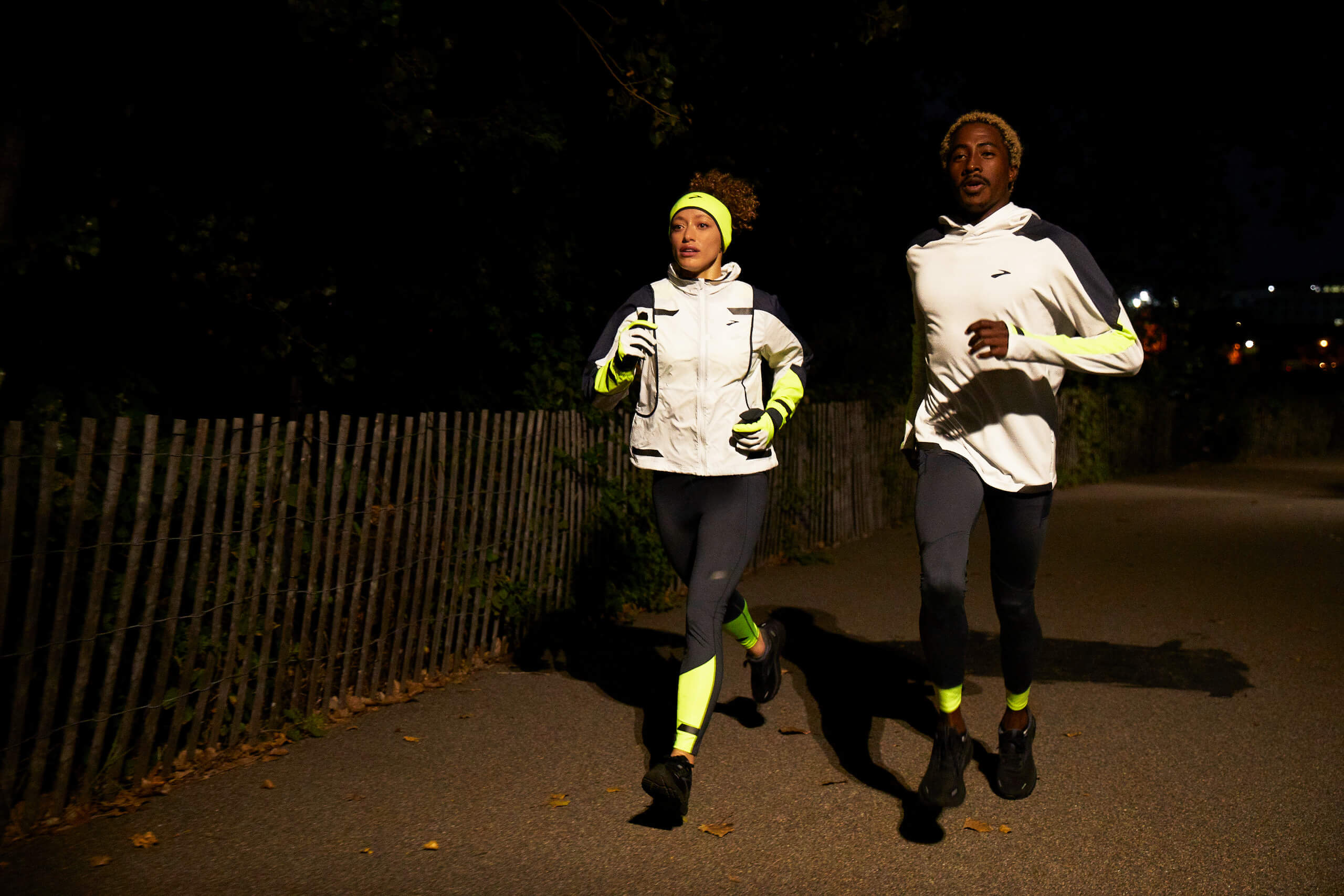 Two people running in reflective clothing