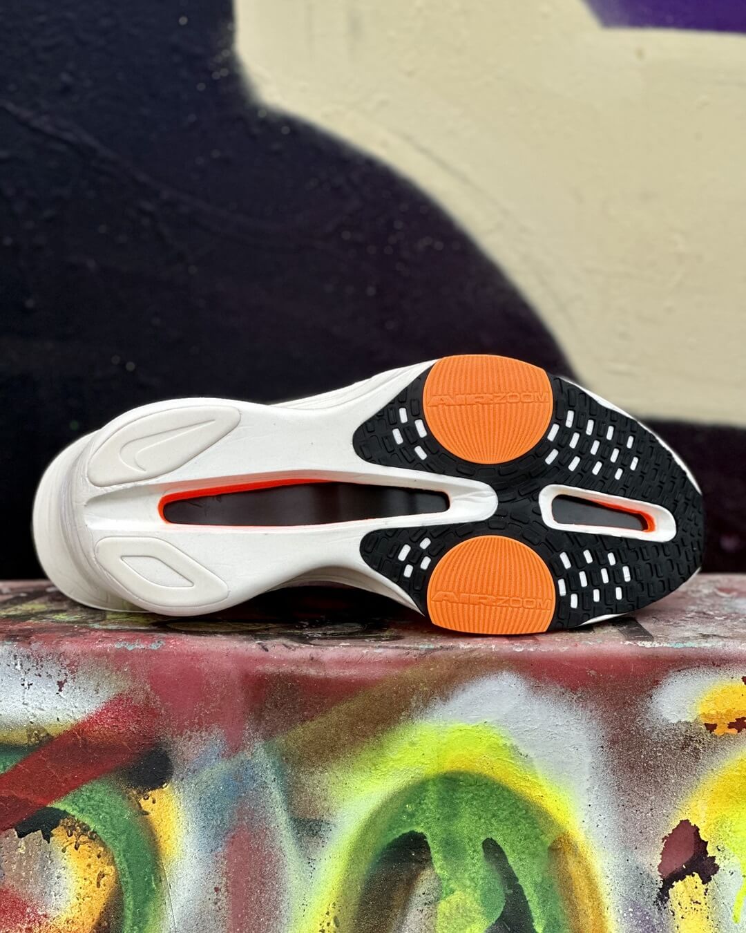 Outsole of Nike Alphafly 3 Proto road racing shoe perched on a graffiti wall