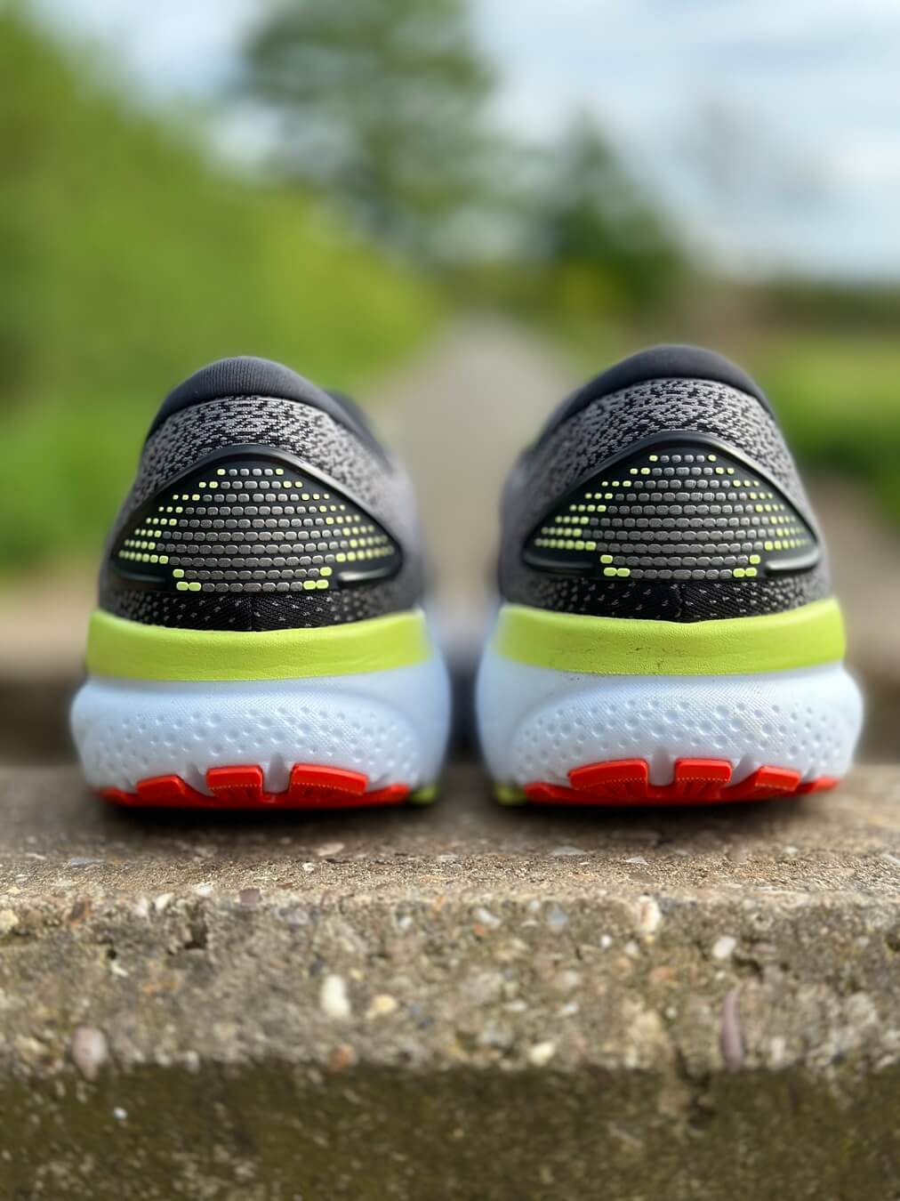 Heel/rear view of pair of running shoes sitting on a wall