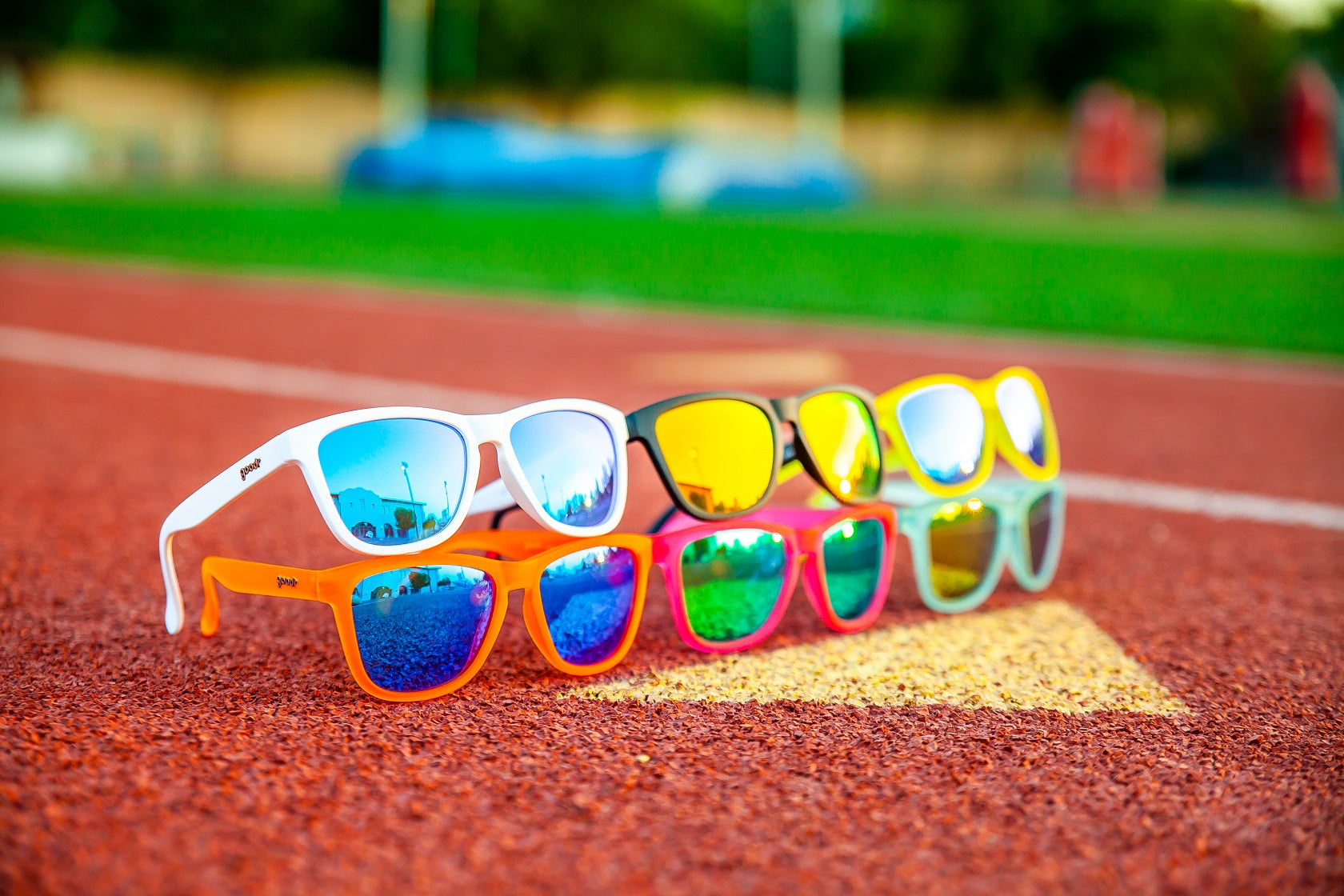 Goodr running sunglasses lined up on running track