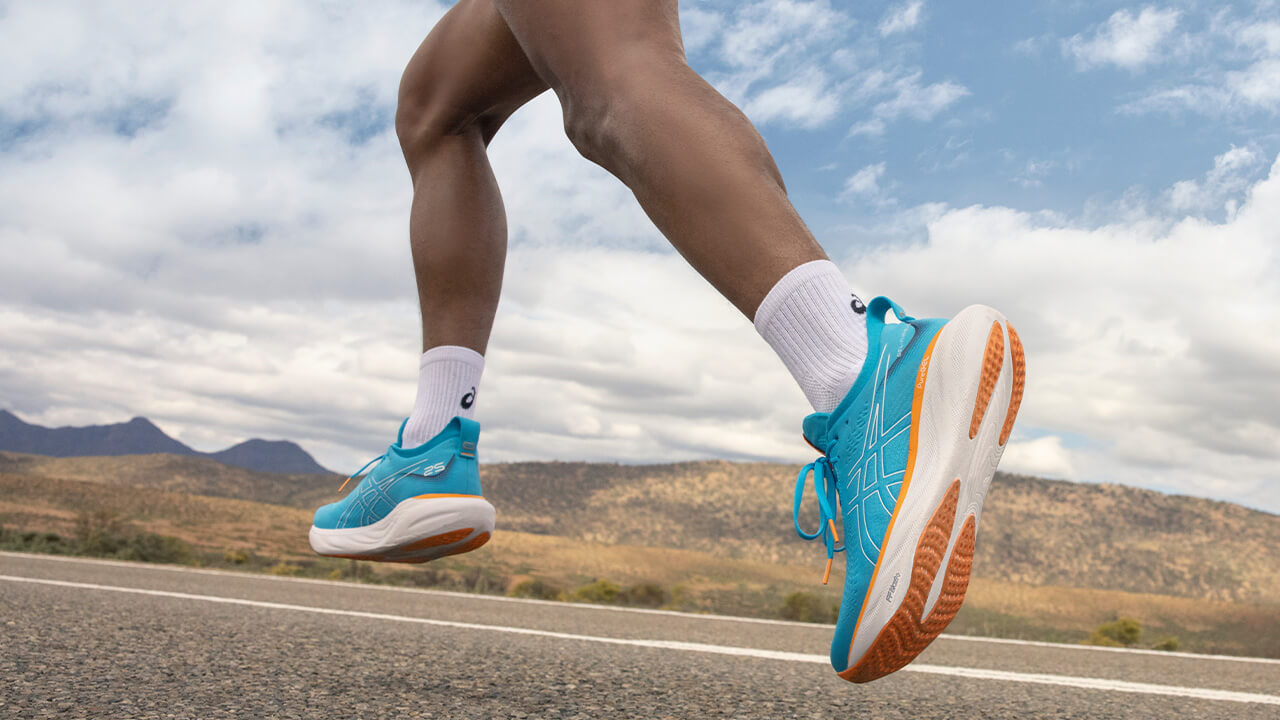 Runner's legs running along a road in Asics Gel Nimbus 25 running shoes