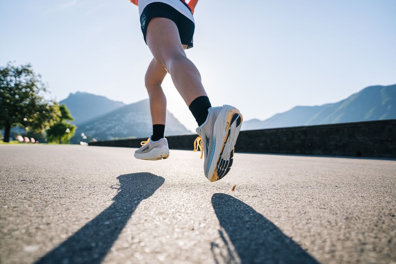 Runner running along promenade in sunshine