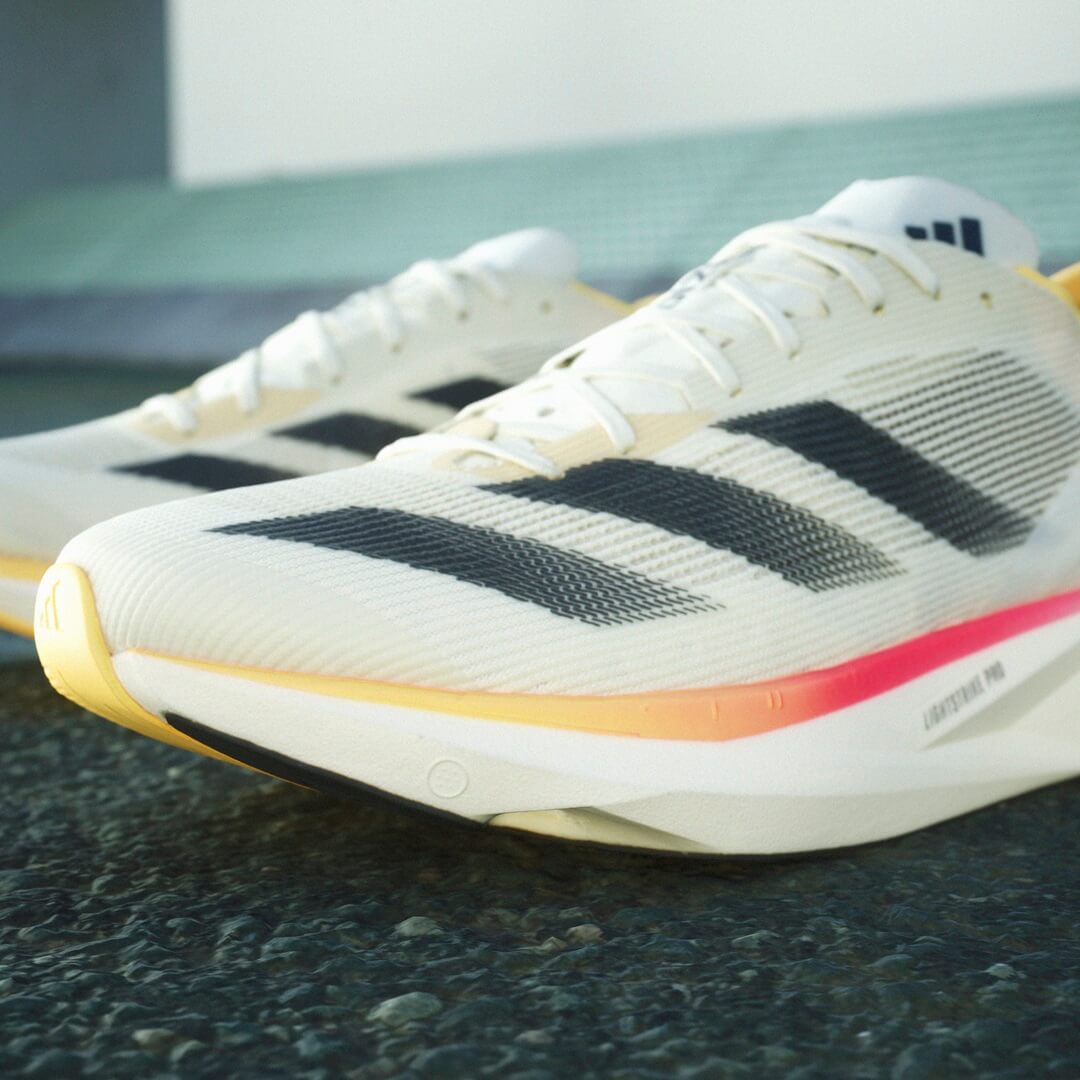 Close up of adidas Adizero Takumi Sen 10 running shoes in Ivory/Core Black/Off White colourway