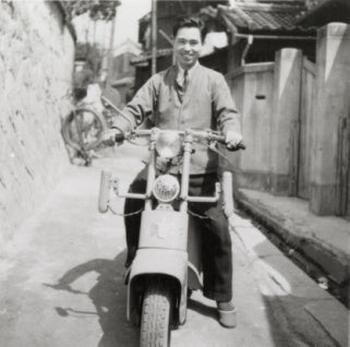Kihachiro Onitsuka on a scooter