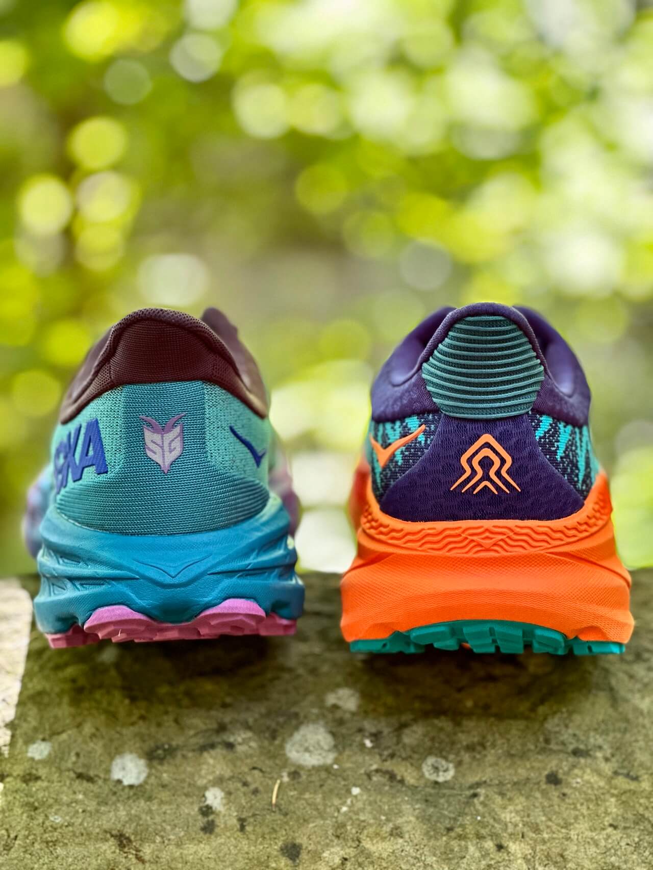 Heel of HOKA Challenger and HOKA Speedgoat trail running shoes shown side by side