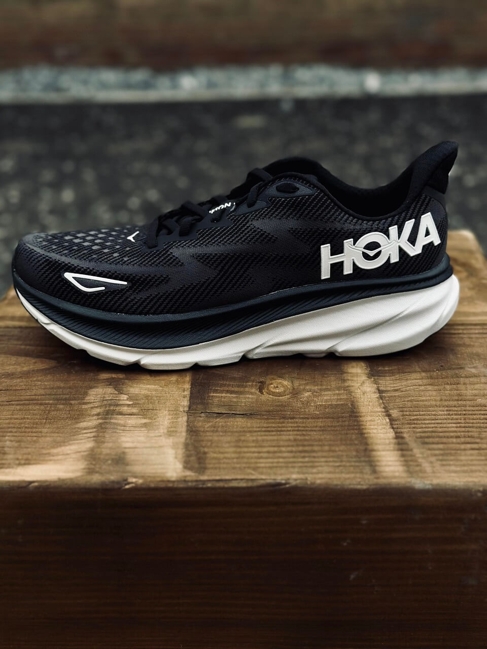 Lateral view of HOKA running shoe in black