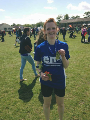 Emma with a medal at the end of a race