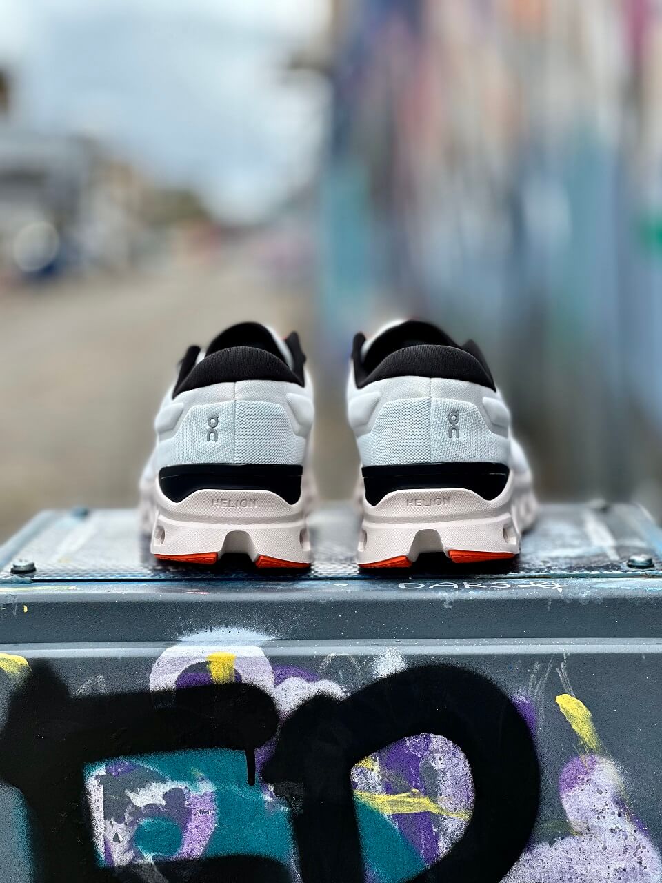 Heel view of On Cloudstratus 3 running shoes perched atop electric box in street