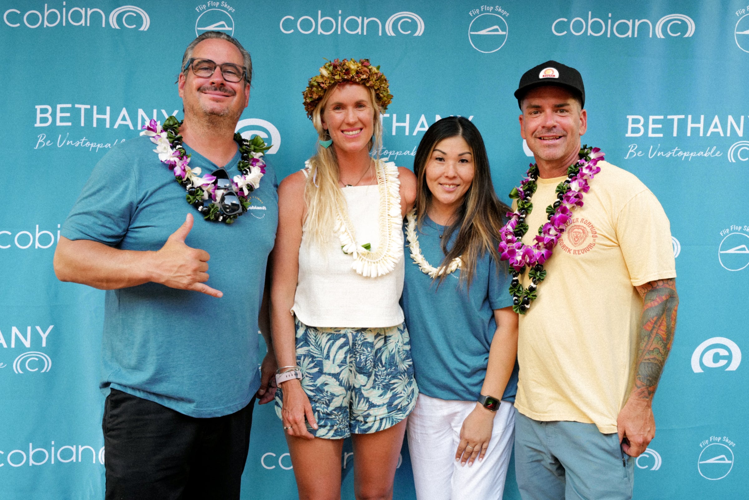 Bethany Hamilton is smiling at camera alongside some Cobian team members.