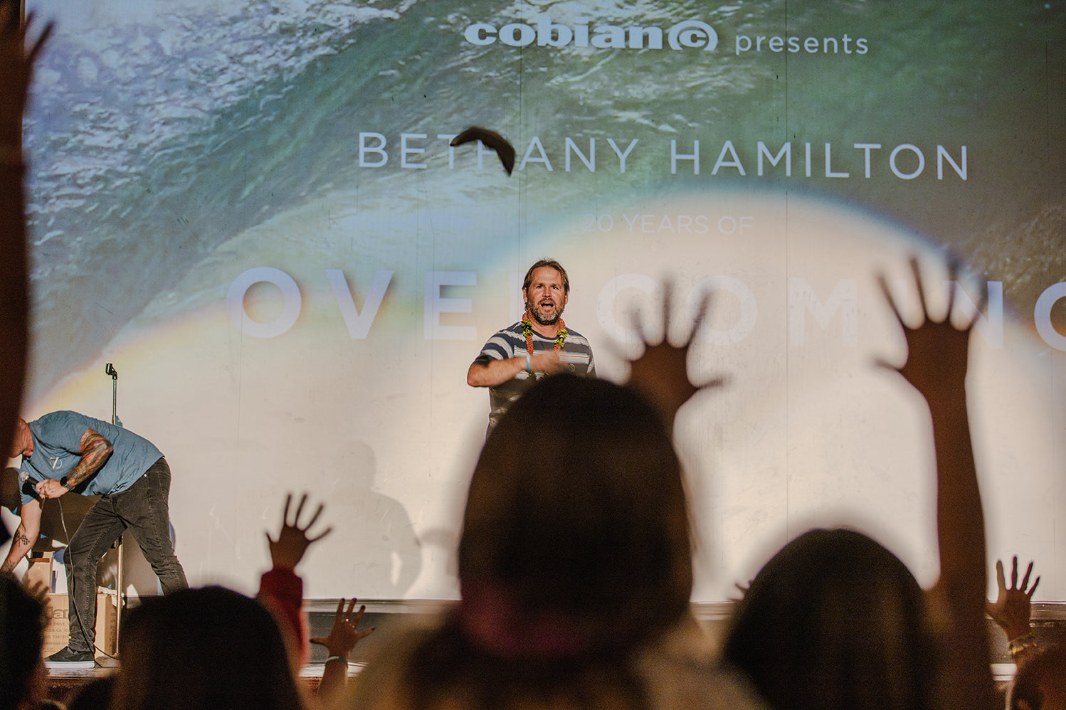 Cobian Ambassador and pro surfer, Damien Hobgood, throwing giveaway items to the sold out crowd.