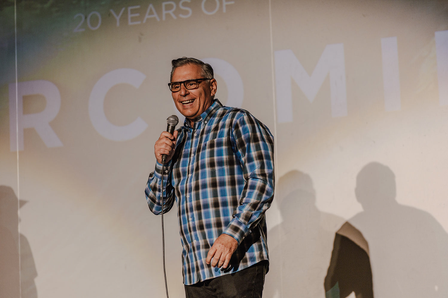 John Cobian, owner and founder of Cobian Footwear, smiling while speaking on Bethany's inspiring faith.