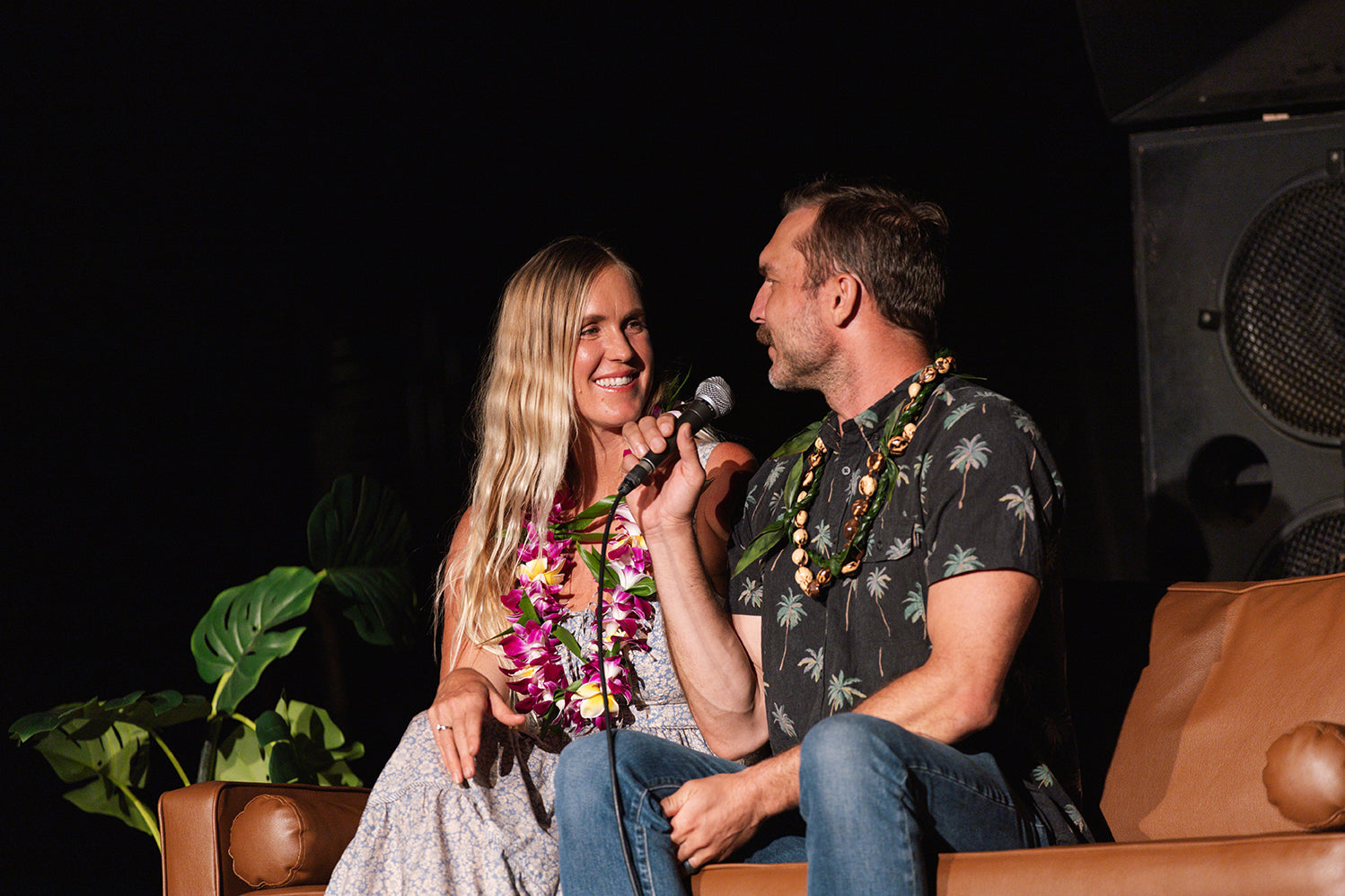 Bethany Hamilton smiling at her husband, Adam, who is retelling a funny story.