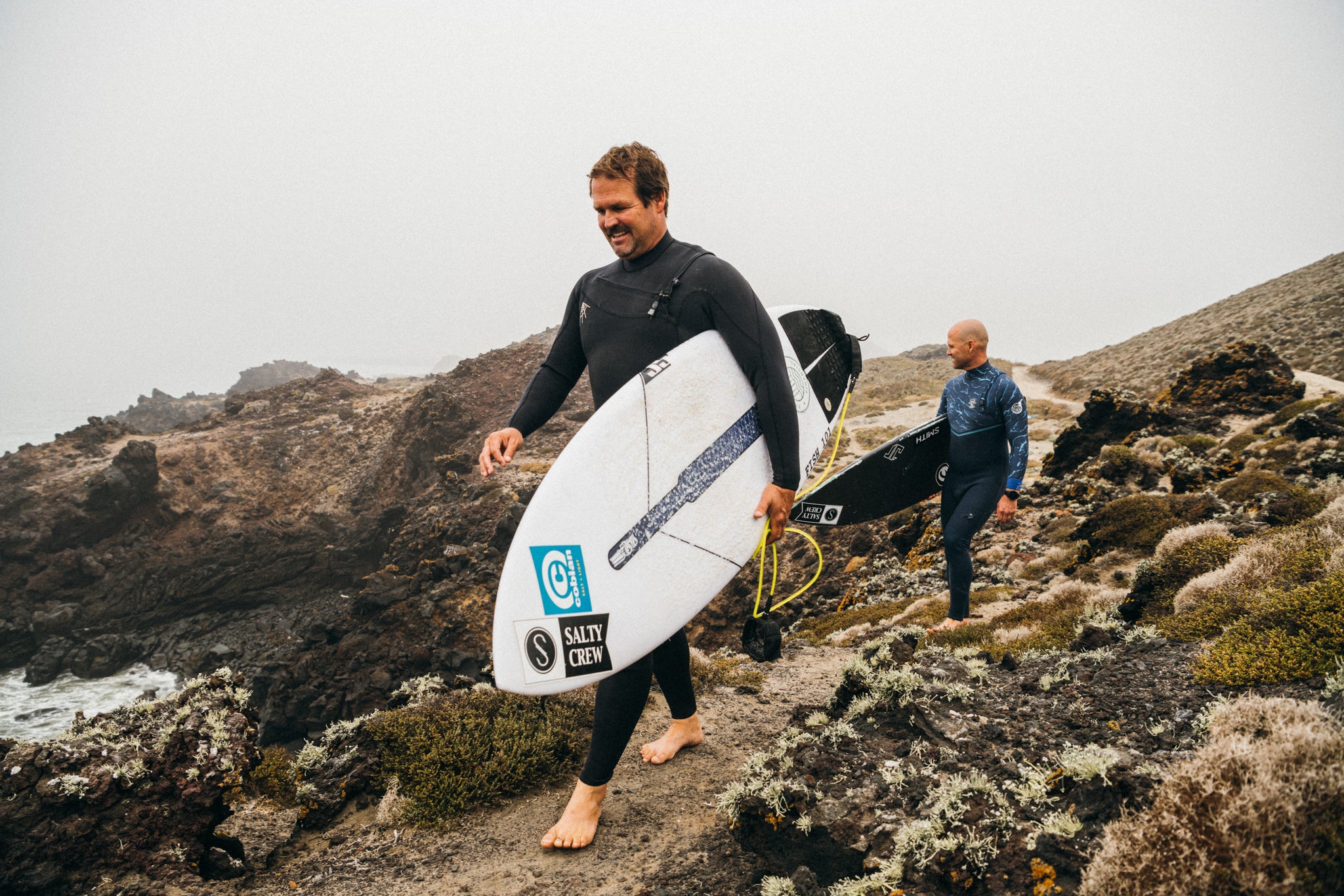 The hobgood brothers walking with their surfboards