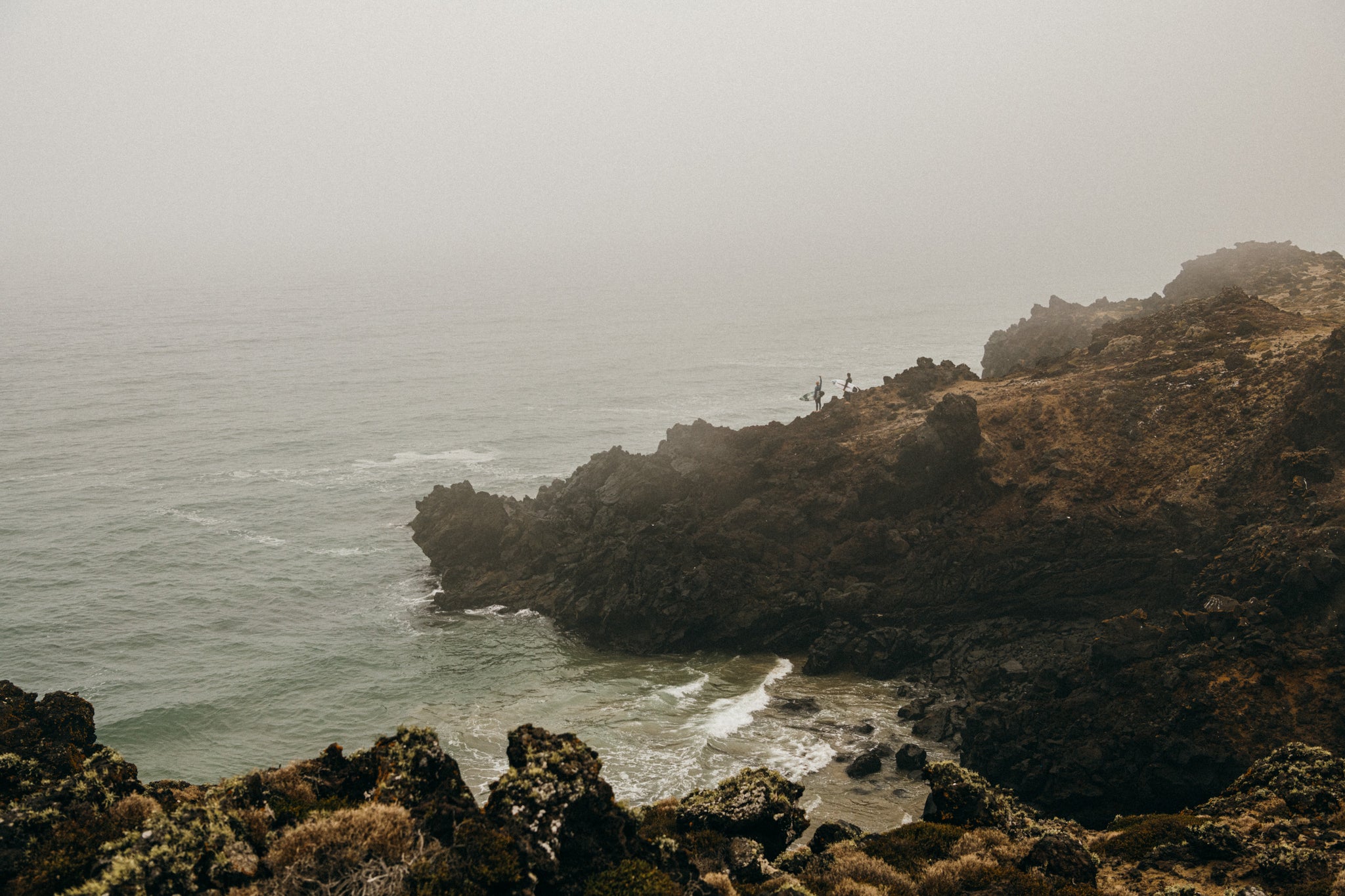 The Hobgoods searching for surf among jagged rock cliffs