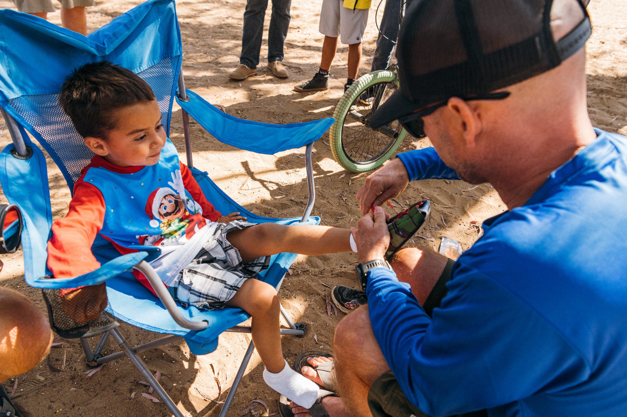 CJ putting shoes on a kid