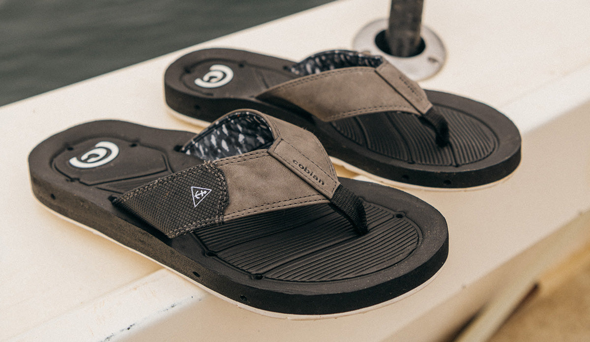 A pair of Cobian Draino 3 sandals on a boat deck