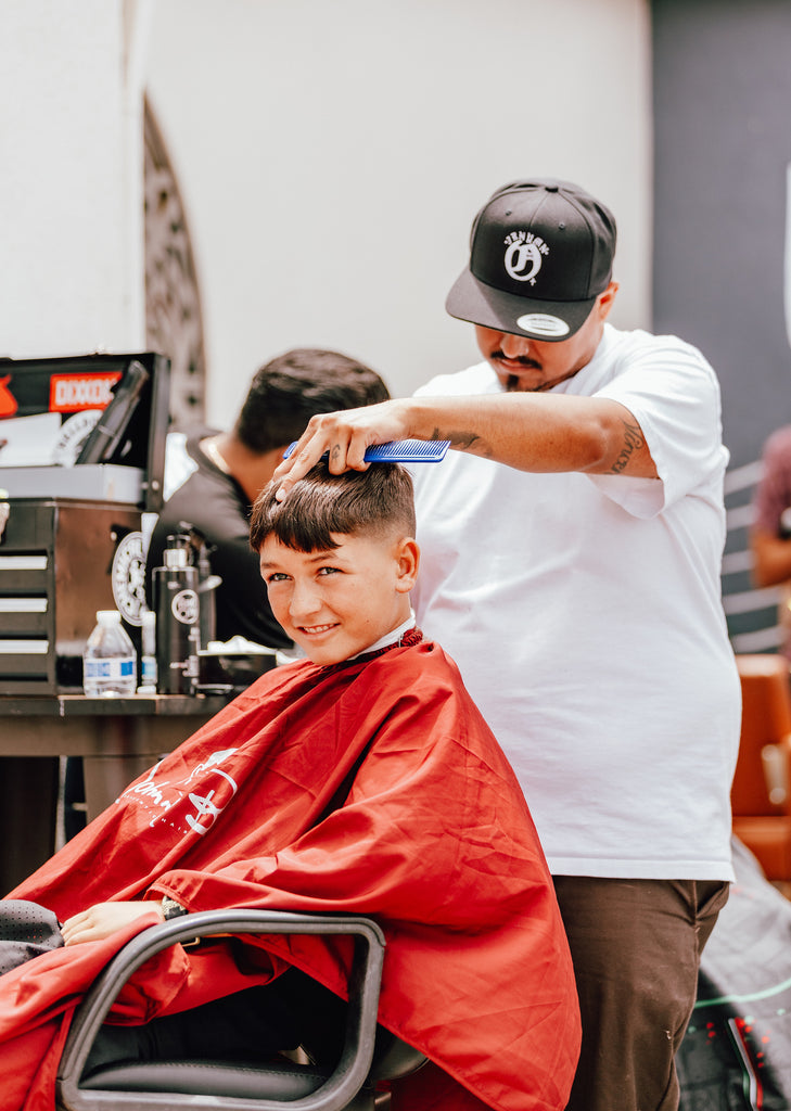 Barber giving a child a haircut