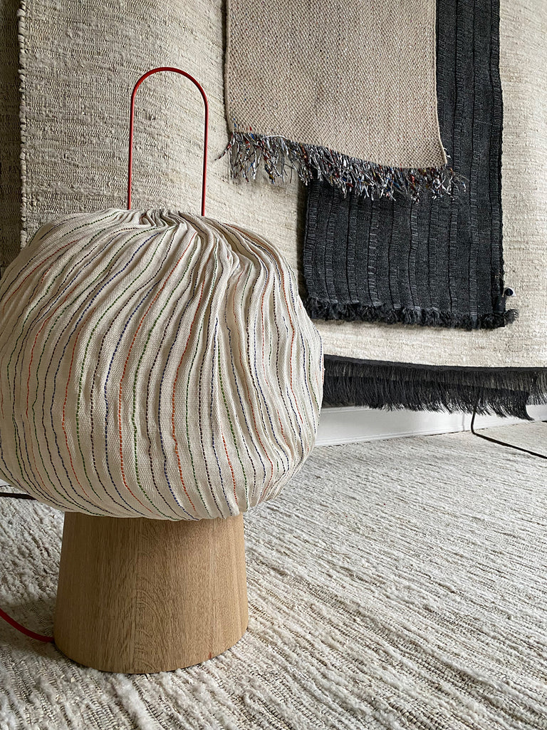 'Coco rug' and 'Rubber rug' by nomad and 'Nebule' lamp (front) with recycled telephone wire by hettler.tüllmann together with artisans of shimena weaving friendships