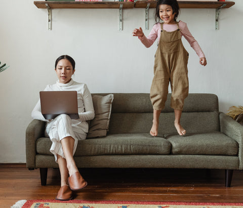 Mother working on computer while child is misbehaving, Mom working from home