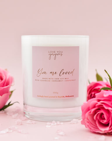 candle  product imagery taken with roses and a pink vinyl photography backdrop by backdrop collective