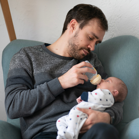 Partner bottle feeding baby