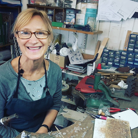 Profile picture of Penny Warren at her bench in her Brighton workshop