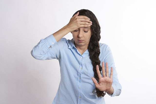 Upset woman who don't want to deal with bad breath on dating.