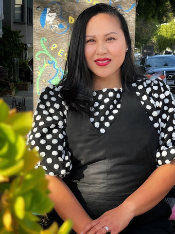 black and white polka dot top and black overalls