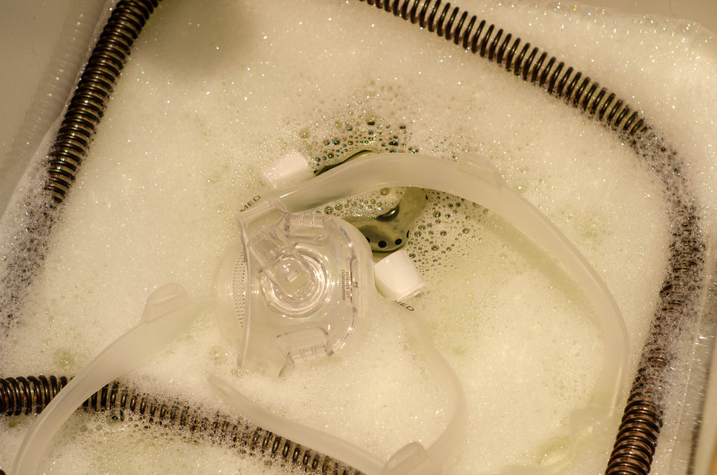 CPAP Machine being cleaned in a skin full of soapy water