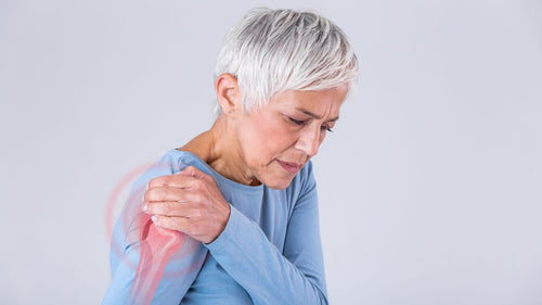 אישה סובלת מכאבים בכתף ימין