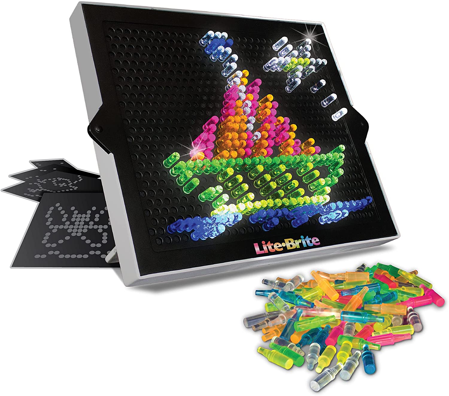 The Lite Brite with a lit-up sailboard on it. A pile of pegs and paper templates lie next to it.