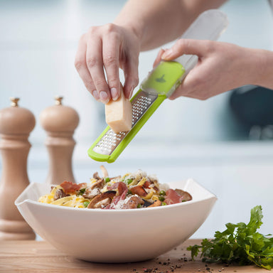 https://cdn.shopify.com/s/files/1/0570/6783/1492/products/zeal-h70_parmesan-grater-in-lime_in-use-with-cheese_384x384.jpg?v=1631630483
