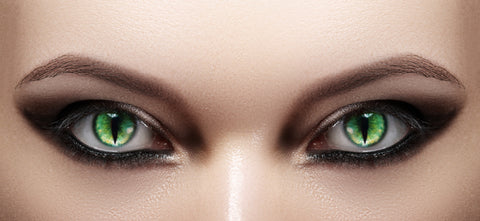 Eyes with smokey makeup and green colored contacts