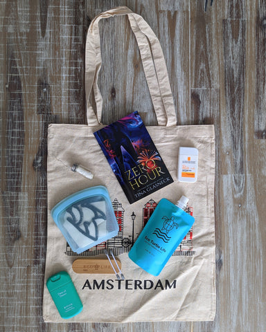 A tote bag with travel essentials on top