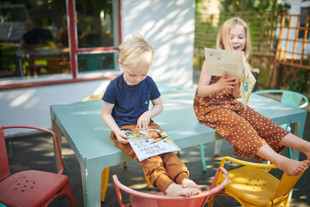 Children reading outside
