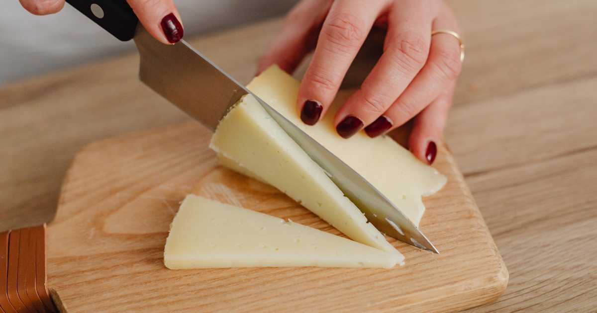 Slicing Cheese on Chopping Board