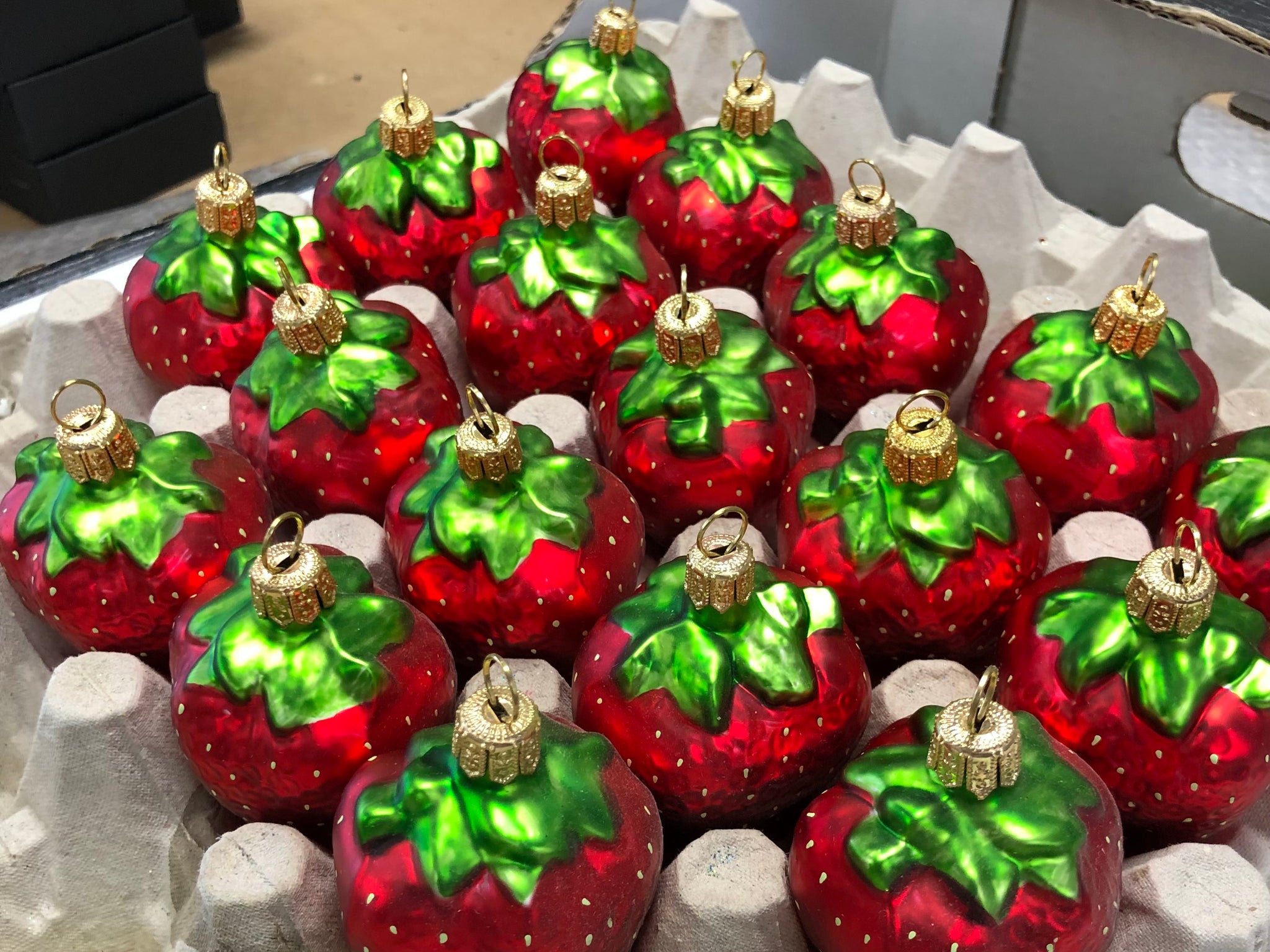 Glass strawberry Christmas decorations awaiting packaging