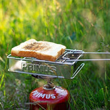 Slice of bread toasting on a Primus Folding Toaster