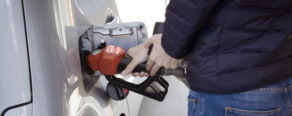 Person filling the tank of his vehicle with fuel