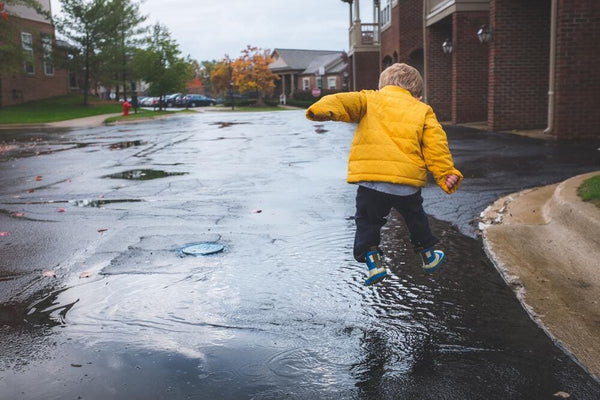 boy jumping in the rain