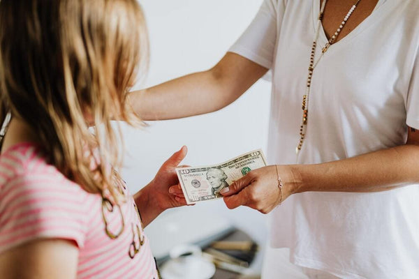 mom giving allowance to daughter