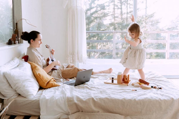 mom playing guitar to baby