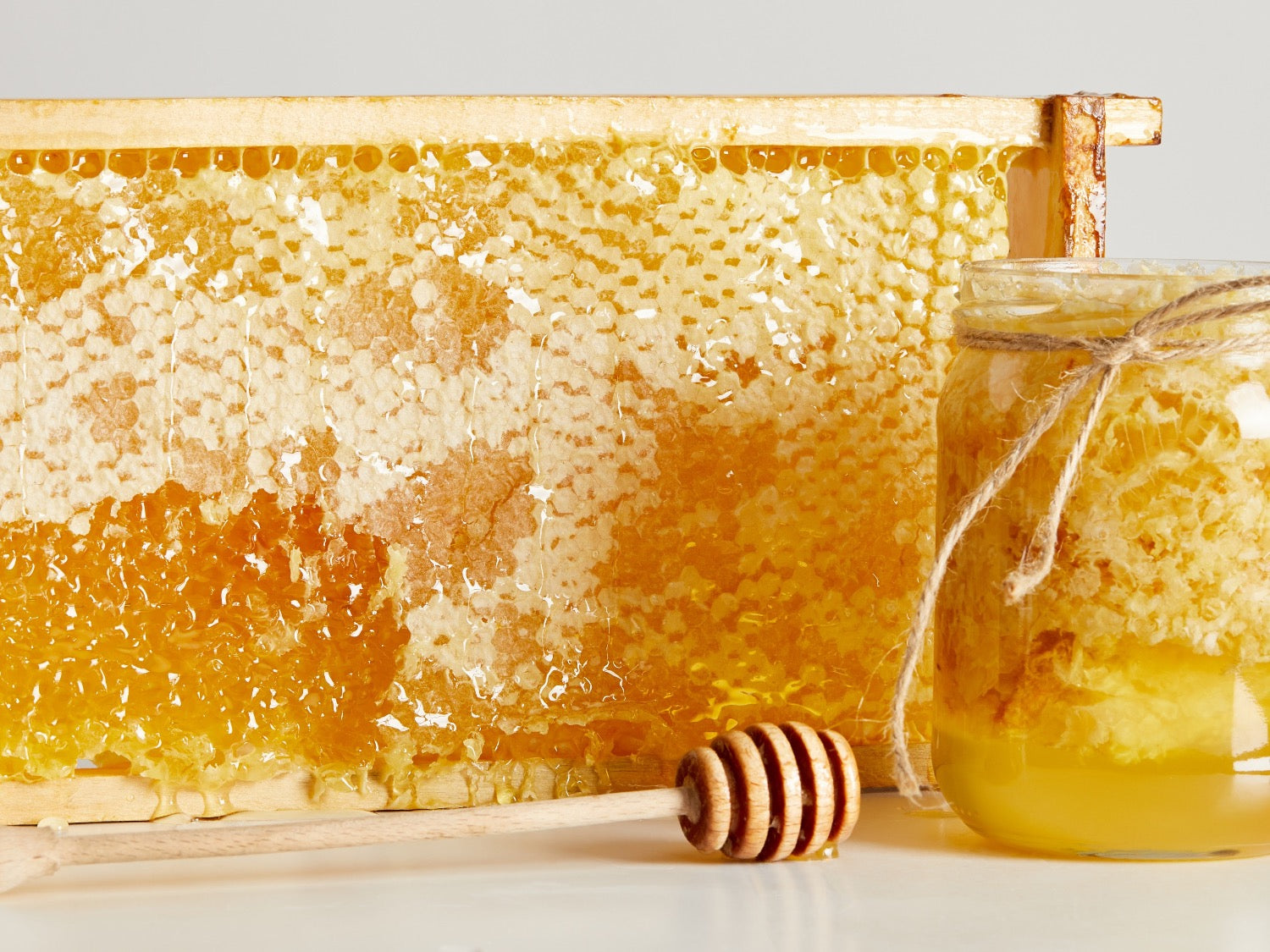 Display of honey, beeswax and honey dipper.