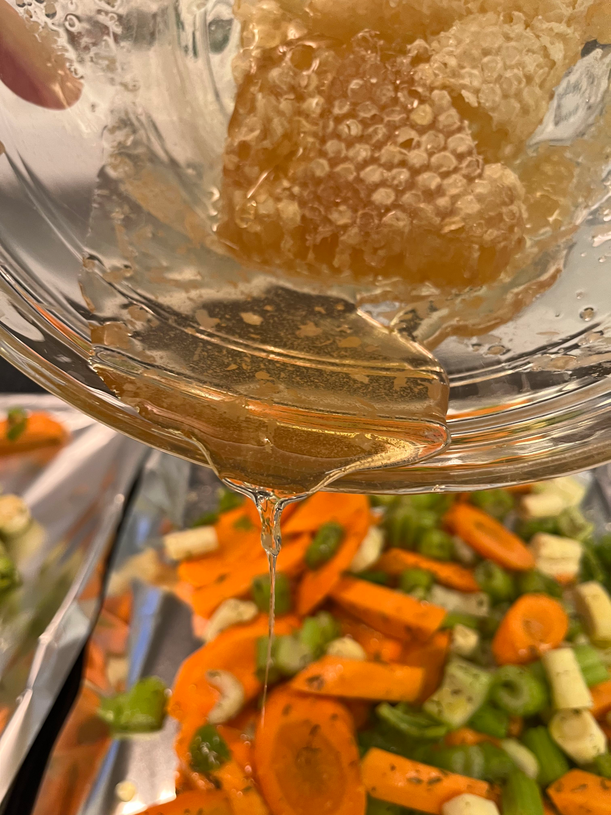 Pouring honey on vegetables.