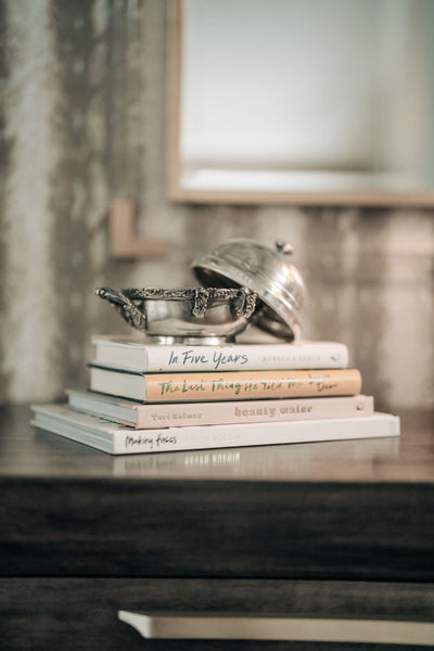 Family heirlooms on display layered on top of books