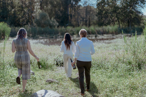 Kathryn, Fiona & Sarah walk through the grass.