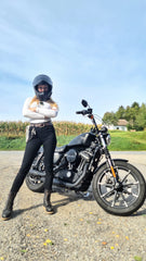 Alex standing next to her Harley Davidson