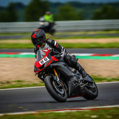 Woman on her racing motorbike on the track