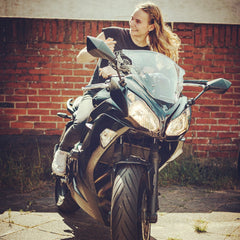 Woman on her motorbike smiling