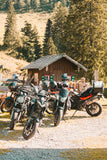 A group of motorcycles at a mountain cabin